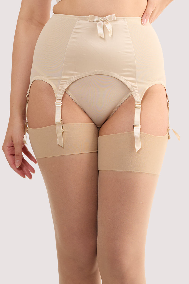 Model wears a champagne satin 6 strap retro everyday suspender with six adjustable straps, soft and smooth finish with a matching brief.