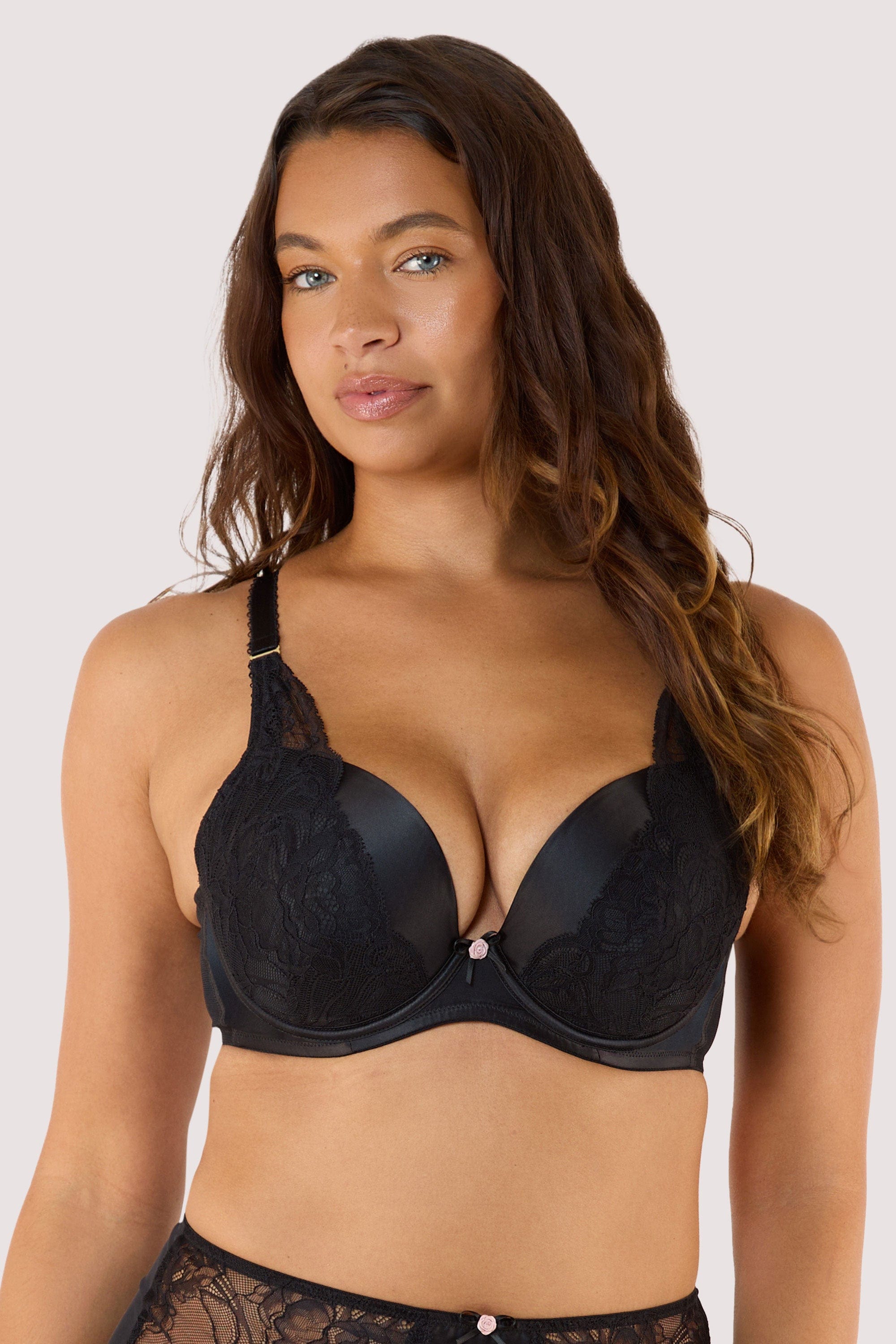 Model wears black padded plunge bra with underwired, padded plunge cups longline underband