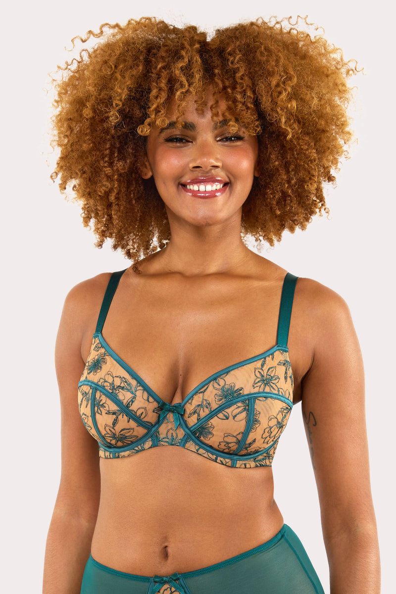 Model wears a teal contrast embroidery balconette bra with underwire plunge cups, nude mesh, and teal floral embroidery, featuring thick adjustable straps and satin seam detailing