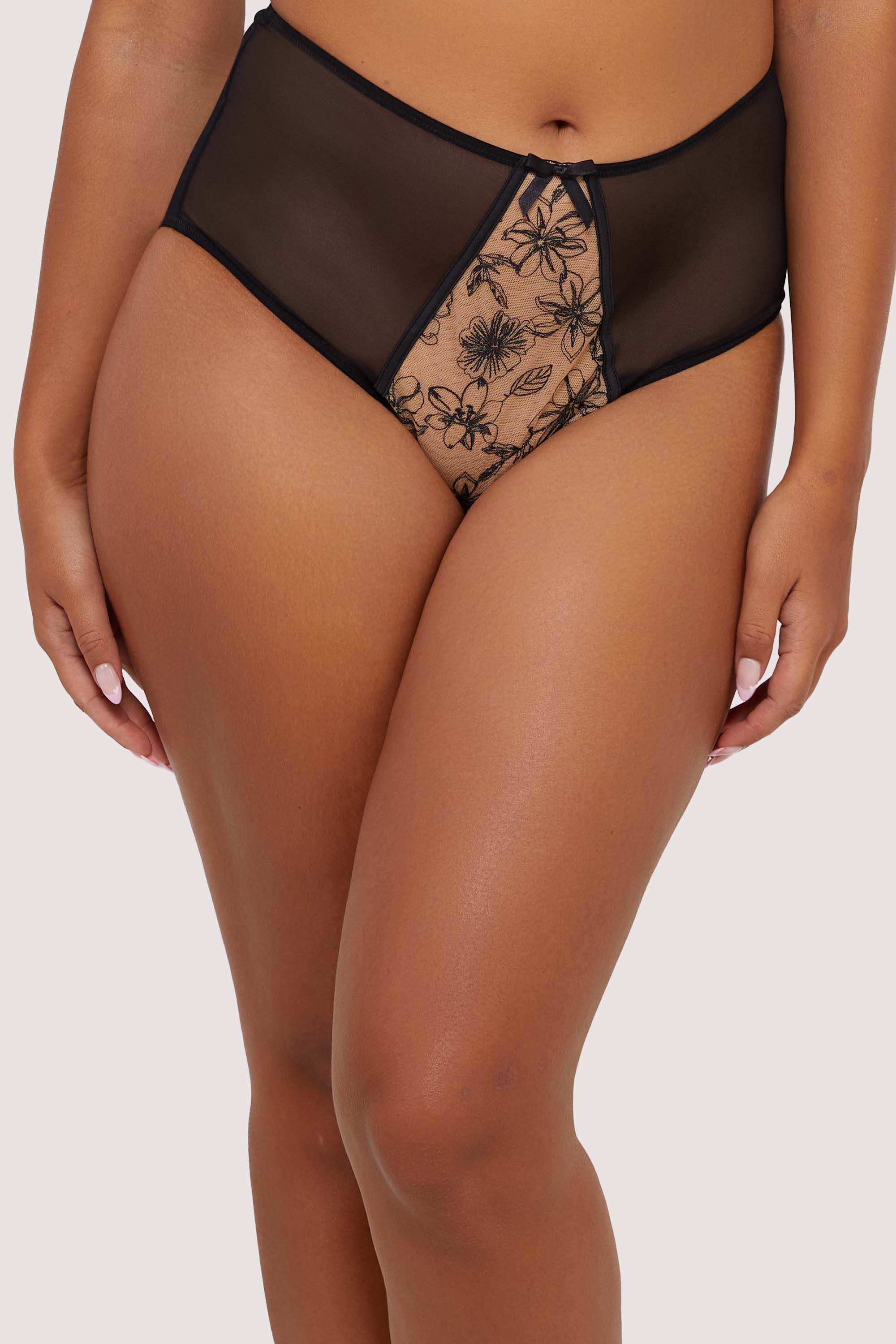 Model wears a black mesh high-waist brief with floral embroidery details