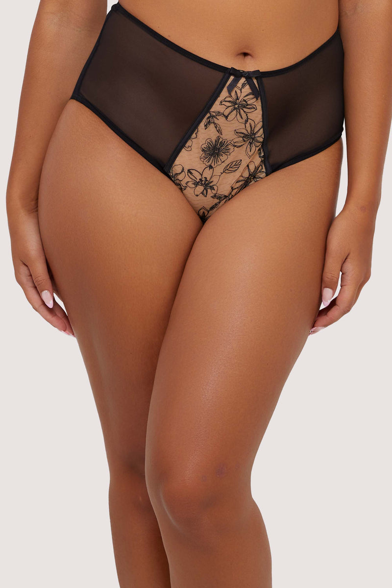 Model wears a black mesh high-waist brief with floral embroidery details