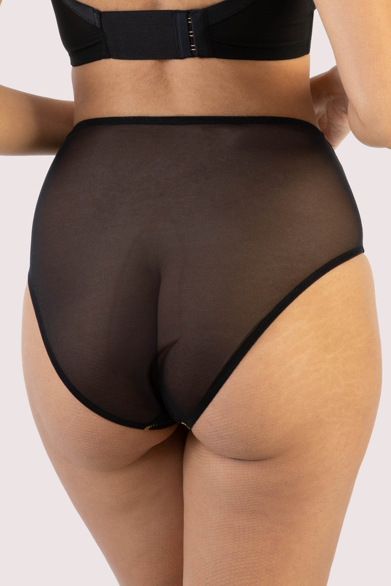 model shows us the back of the Solar black and gold cosmic print high waist brief