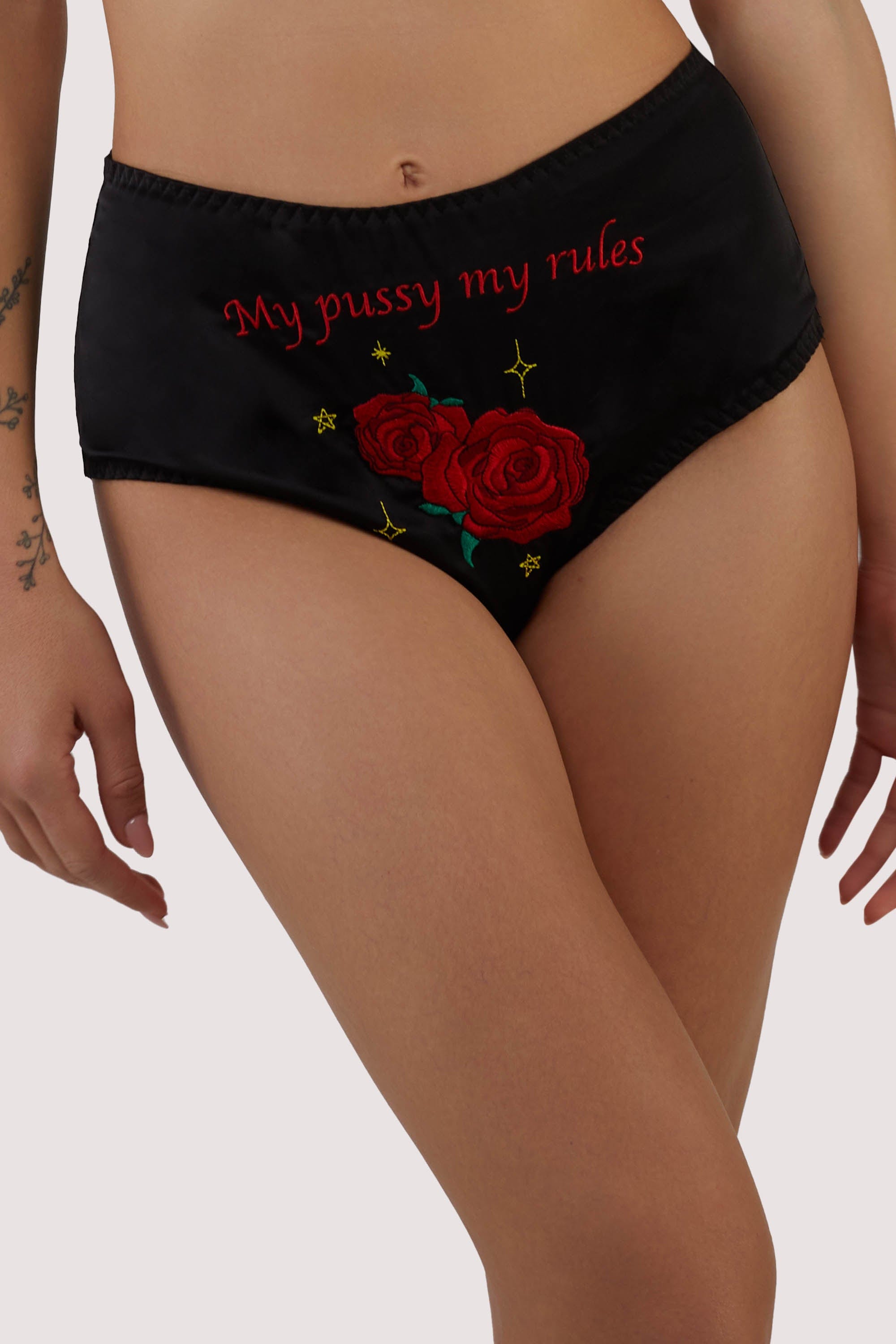 model wears black satin high waist briefs with retro emboidery