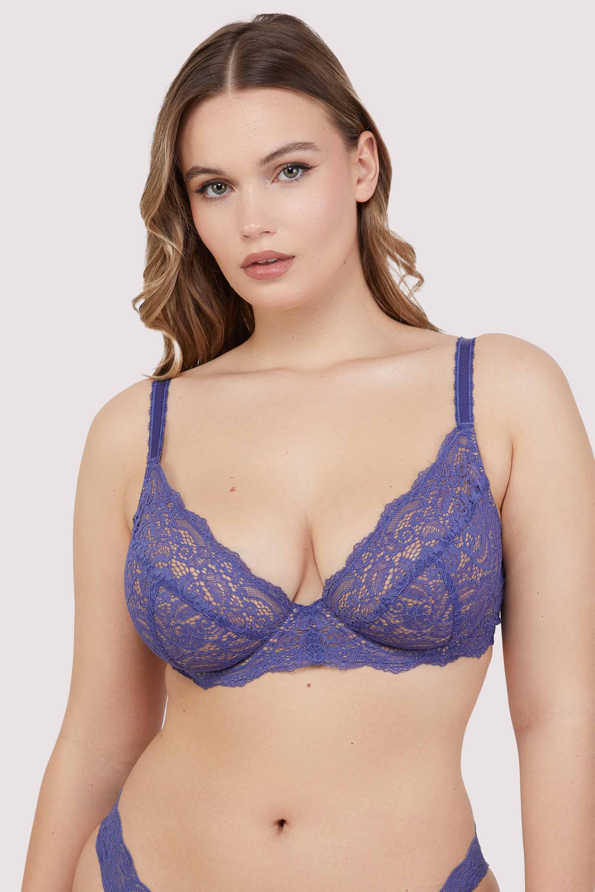 Wears Blue lace bra with underwire and adjustable straps