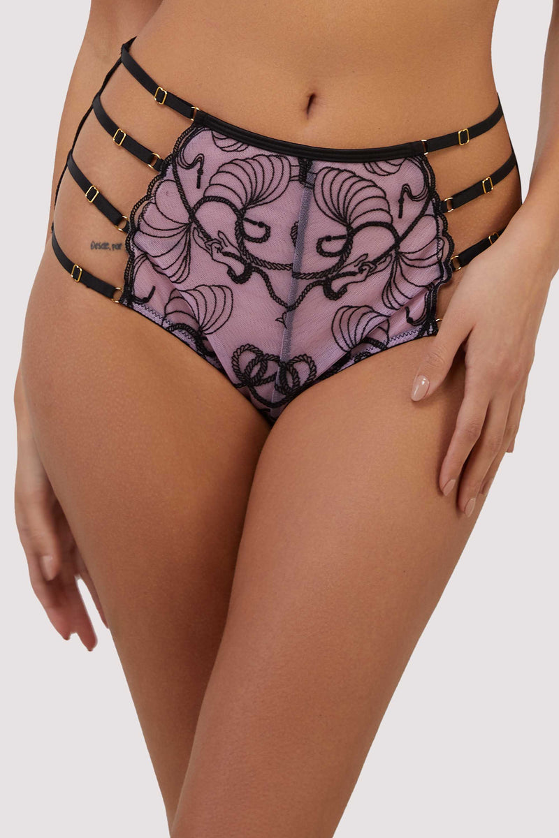 model wears pink and black embroidered high-waist strap brief
