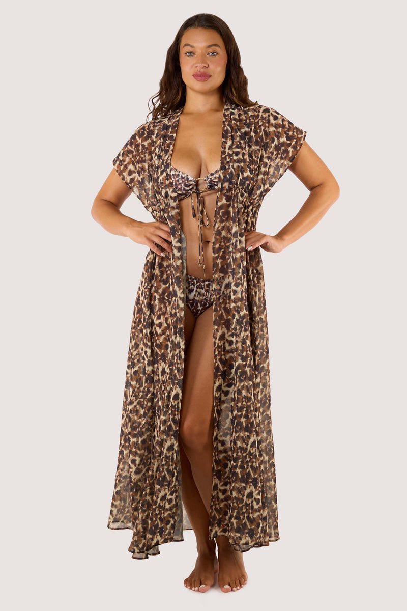Model Front view of the Zarah Animal Print Georgette Long Beach Kaftan worn open over a bikini, highlighting the plunging neckline, adjustable underbust tie, and wide sleeves.