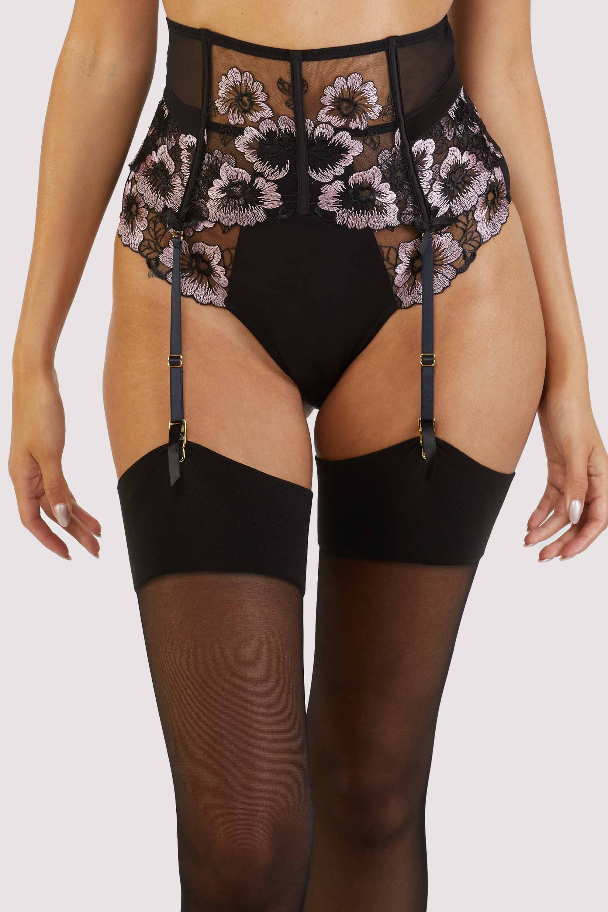 Waspie with panelled black mesh and satin, delicate black and pale pink floral embroidery and black bows on each of the 4 suspender straps.