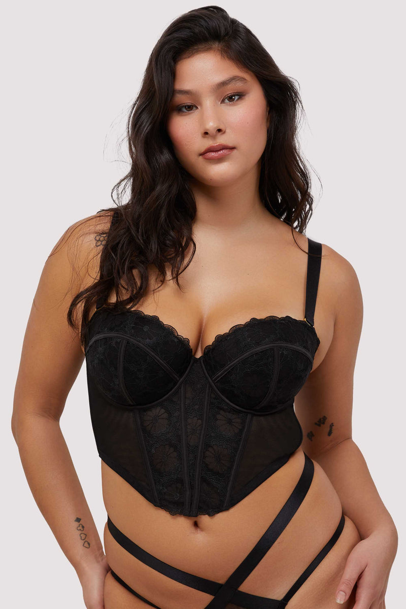Model wears black embroidered mesh boned bustier with removable shoulder straps and underwire cups