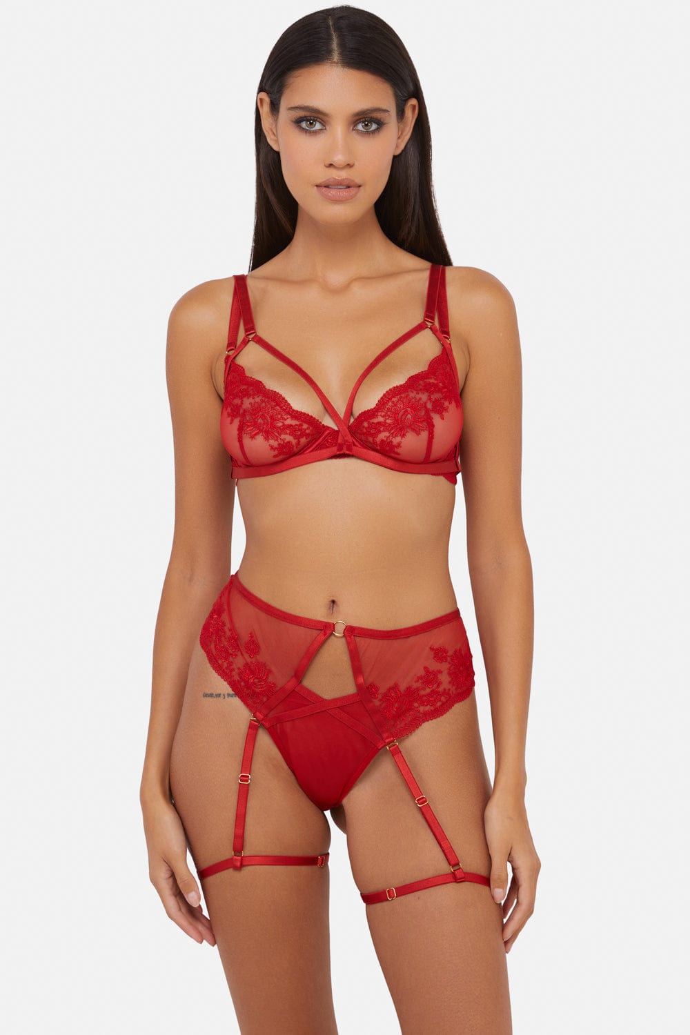 Model wears a red lace plunge bra and high waist suspender brief lingerie set
