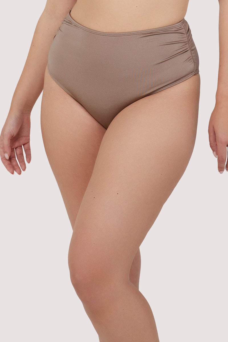 Model wears high-waist high-leg taupe bikini bottoms