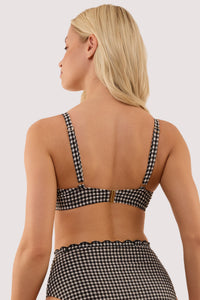 Model shows the back of a margot black & white gingham scallop trim underwire bikini top with adjustable straps and metal clip fastening.
