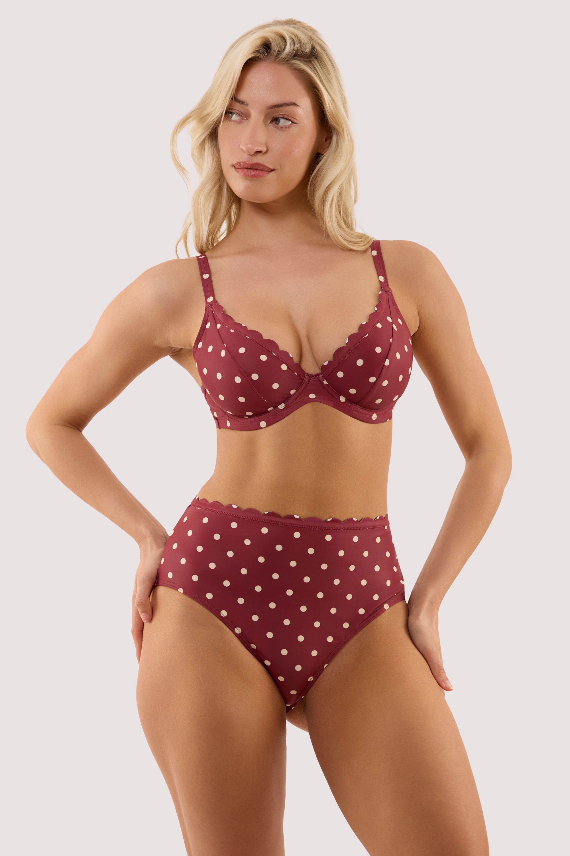 Model wears a hazel wine spot high waist bikini brief with a matching bikini top.