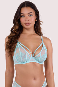 Model wearing aqua embroidery & mesh plunge bra featuring sheer aqua mesh, floral embroidery, and harness-style strap detailing with gold-tone hardware