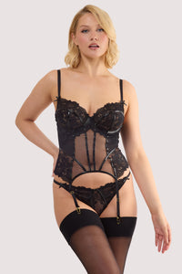 Model wears a samara black leatherette & lace basque with leatherette and lace panelling, adjustable shoulder and suspender straps with a matching thong.