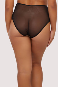 Model shows back of high-waist black thong mesh fabric, offering minimal coverage with a smooth, seamless design