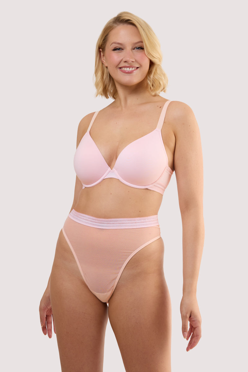 Model wears a icon blush pink high waist thong with light pink supportive mesh and Linear waistband trim with a matching bra.