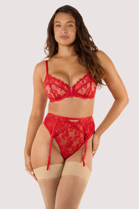 Model wears a red suspender belt with machining lingerie showcasing transparent mesh and satin strap details