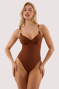 Model wears a tamzin chocolate brown underwired swimsuit with hardwear with underwire cup and a metal clasp fastening.