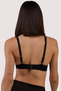 model shows the eye hook of Anita black mesh cut out bow bra