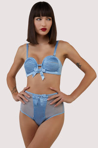 model wears retro blue satin bra and briefs
