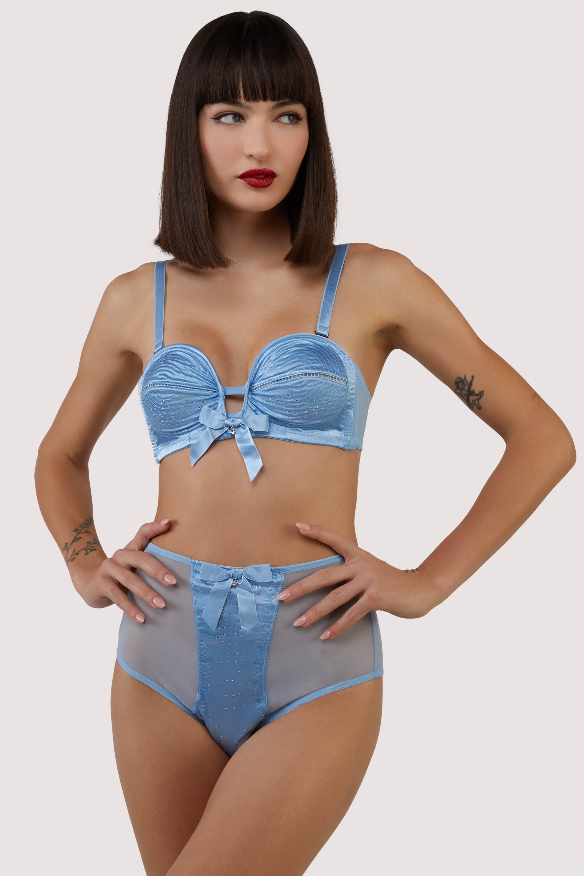 model wears retro blue satin bra and briefs