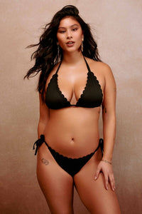 model wears black scalloped triangle bikini and tie side bottoms swimwear set