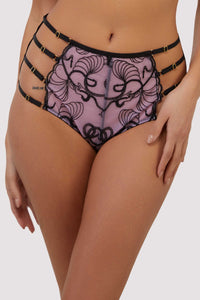 model wears pink and black embroidered high-waist strap brief