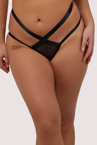 Model wears black strappy mesh Brazilian briefs