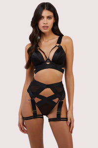 model wears black mesh bra, high waisted thong and black mesh multi-strap harness suspender