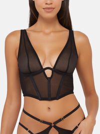 Model wears a black mesh plunge basque with underwire cups, open cradle, and adjustable straps
