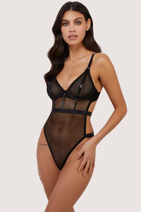 model wears Selena black high leg fishnet bodysuit
