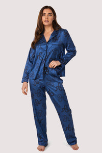 Blue satin pyjamas with a pocket on the breast, in a black snake print design.